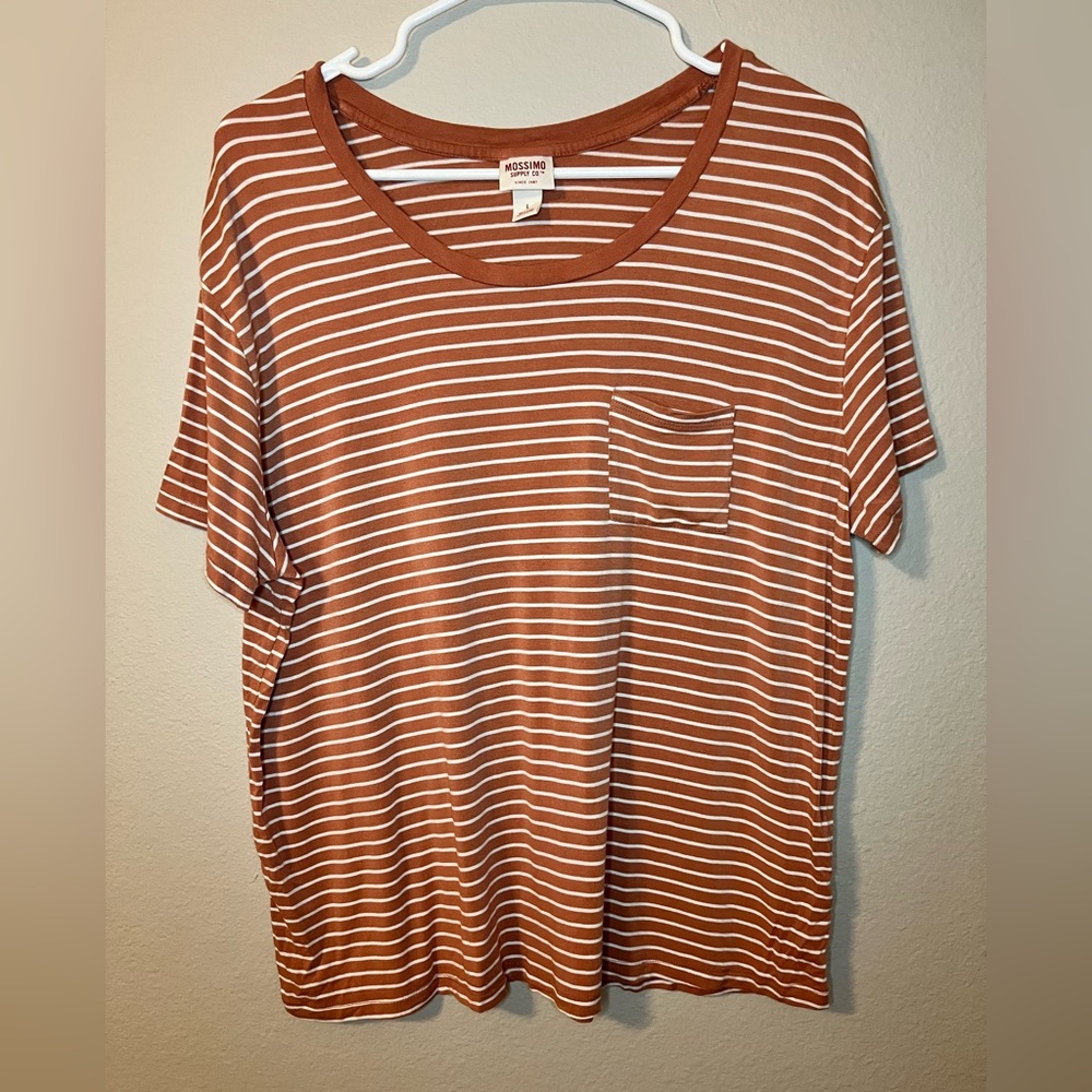 Women’s Large orange and white stripped shirt with pocket on front.